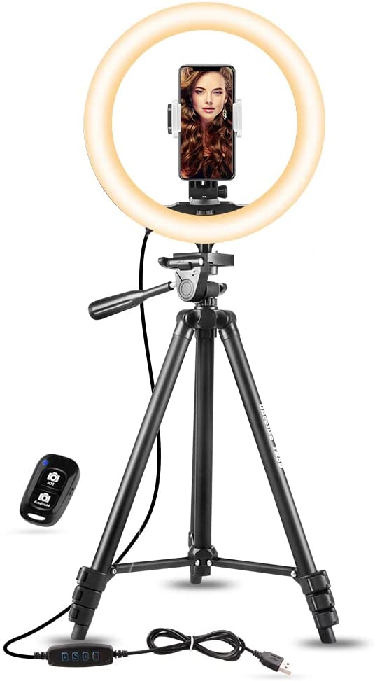 A large ring light fitted with a phone.