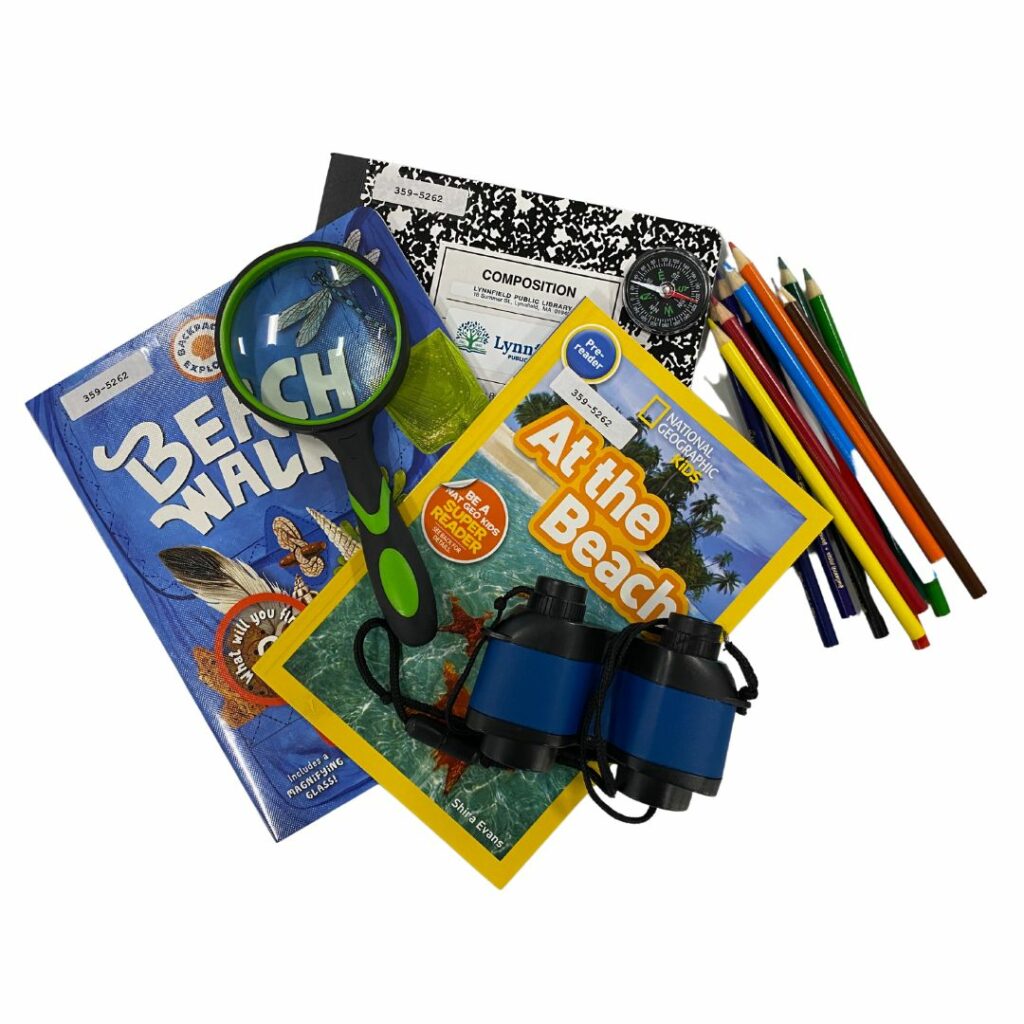 A collection of books and other materials that are part of an Explorer kit designed for kids to explore the beach and write down their findings.