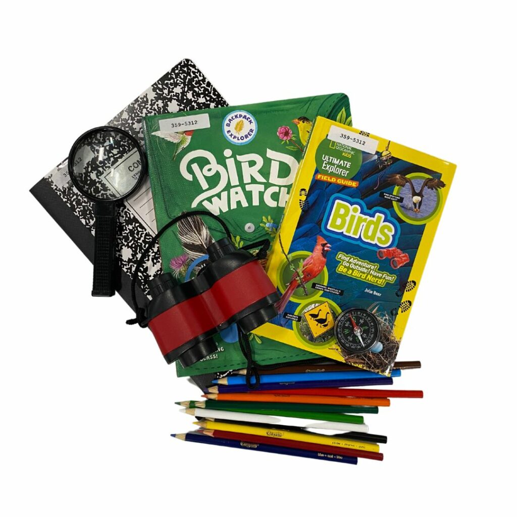 A collection of books and other materials like a compass and binoculars as part of an explorer kid which encourages kids to get out and explore nature. This kit focuses on birds